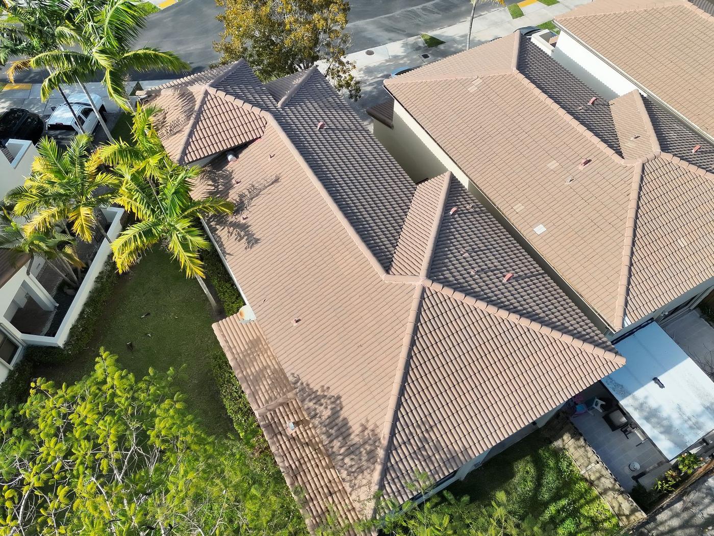 High-resolution aerial drone photo of residential tile roofs during a roof inspection in Miami-Dade