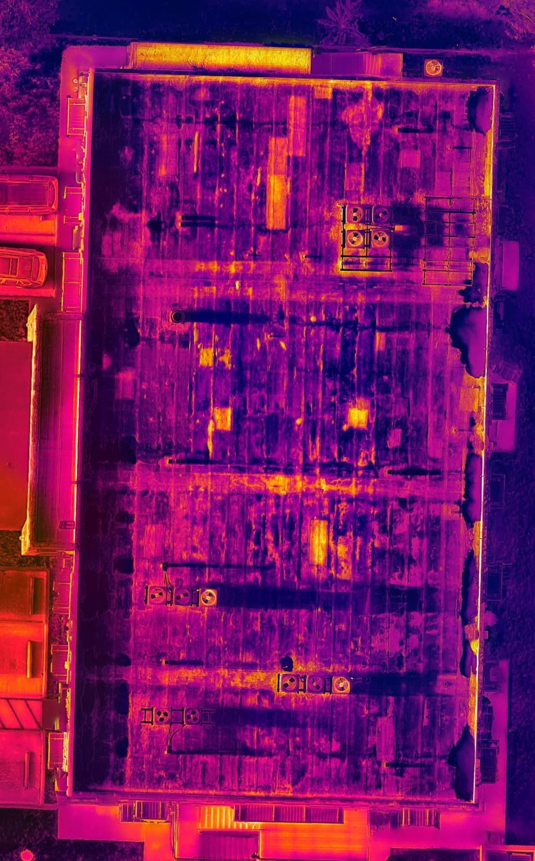 Radiometric thermal orthomosaic of the same commercial roof showing suspected moisture anomalies
