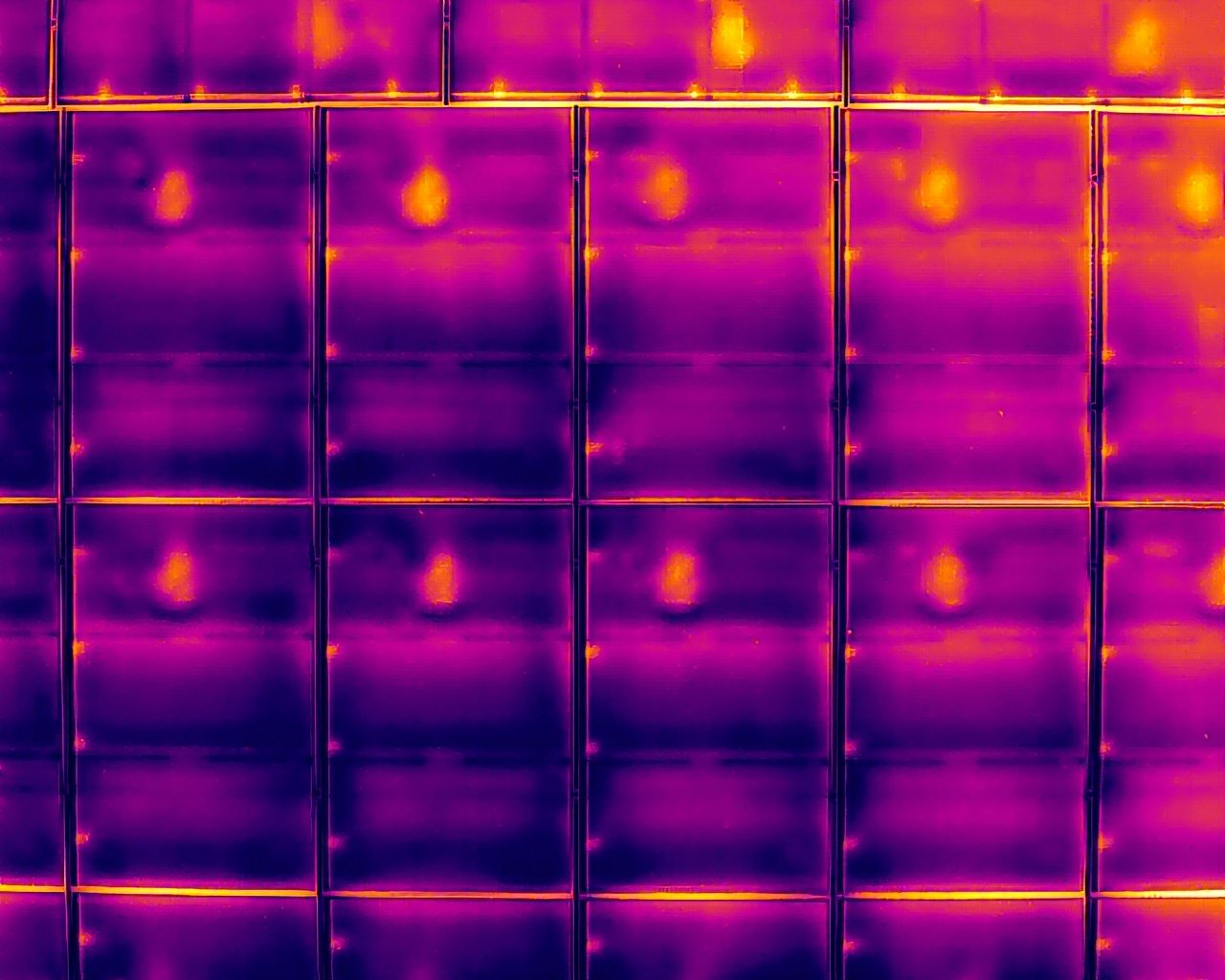 Module-level radiometric thermal image of solar panels showing hotspot anomalies during a PV thermal survey