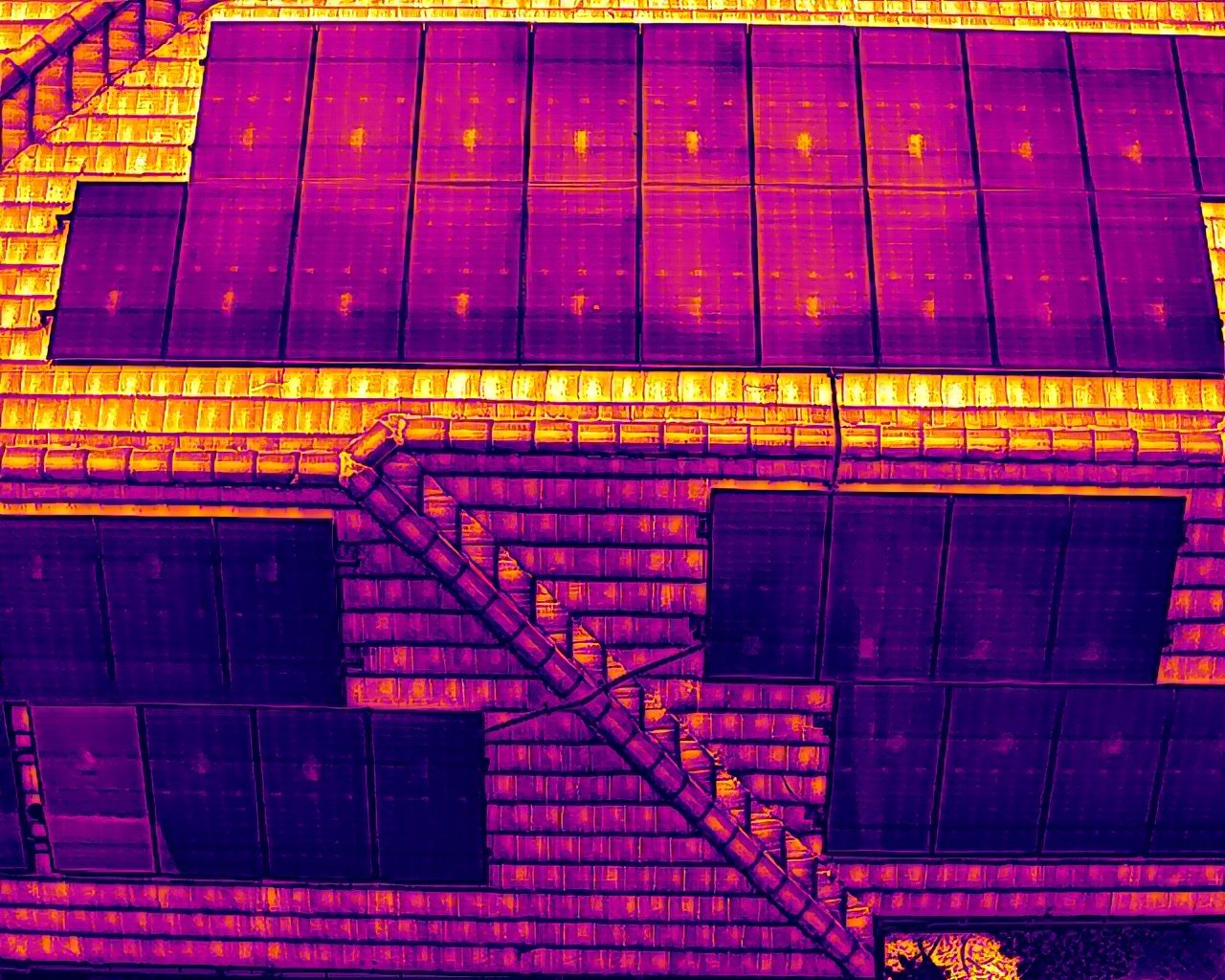 Radiometric thermal survey of a residential tile roof with rooftop solar panels in South Florida